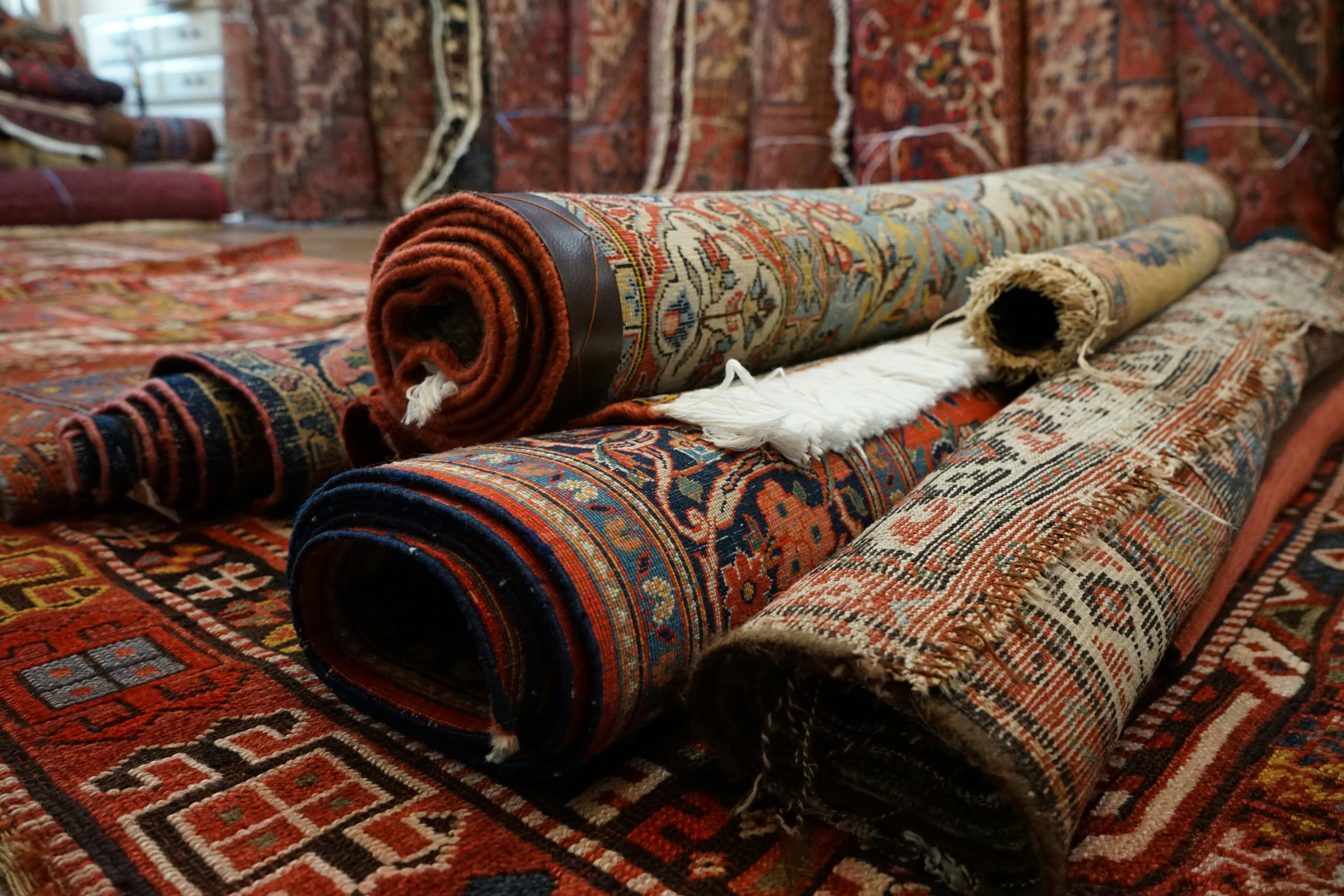 Rolled-up oriental rugs — proper storage protects the warp threads